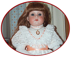 Treasured Heirlooms Designs logo--antique doll in custom-crocheted dress